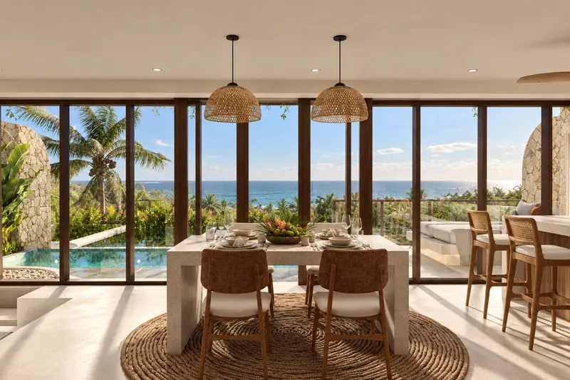 Comedor con ventanales de suelo a techo abiertos al mar