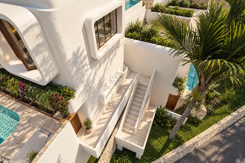 Escaleras exteriores blancas entre jardineras, palmeras y piscinas